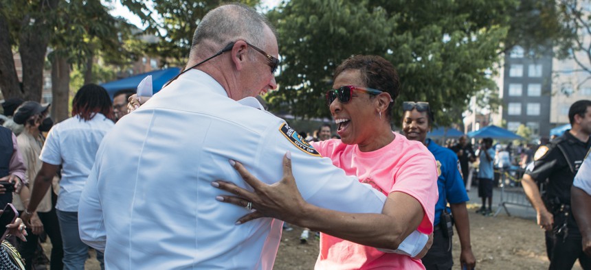New York City Council Speaker embraces a member of the NYPD at the National Night Out Against Crime on Aug. 2, 2022.